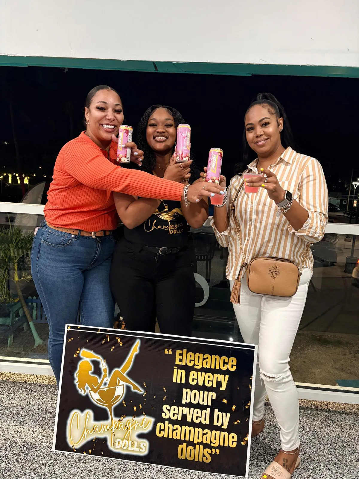 Three women cheers'ing with ePleazze cans